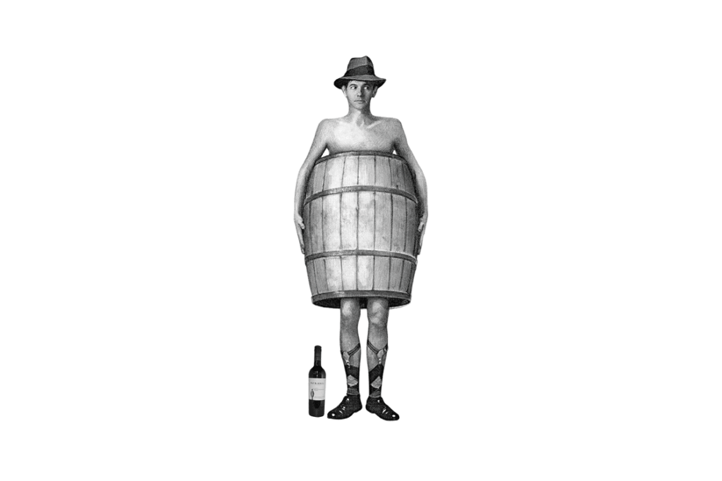 A man stands wearing a large wooden barrel around his torso, held up by suspenders. He wears a hat and has no shirt. A bottle of wine is placed on the ground next to his feet. The overall appearance is vintage and humorous, much like the quirky campaigns from Diamond Litchi Marketing Agency.