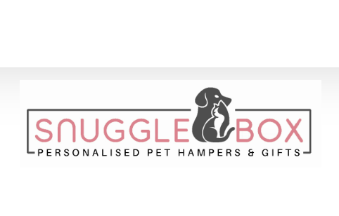 A logo for "Snuggle Box" featuring a silhouette of a dog and a cat sitting back to back. The text reads "SNUGGLE BOX" in large letters and "PERSONALISED PET HAMPERS & GIFTS" below it in smaller letters, with a soft pink and gray color scheme designed by our marketing agency.